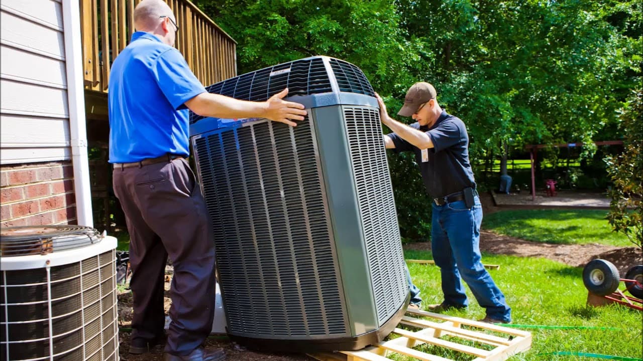 Air Factory technicians installing an outdoor AC unit