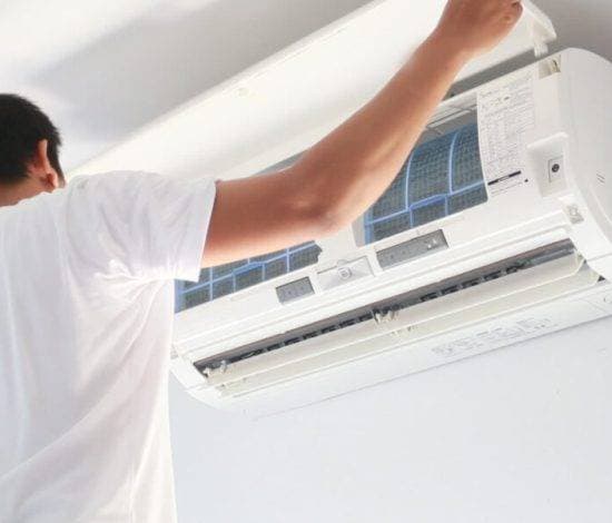 Technician servicing an indoor mini split