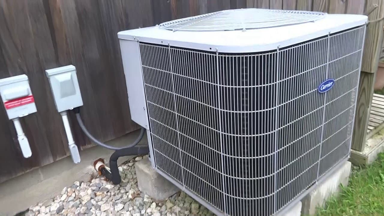 Air Factory technician repairing an outdoor air conditioning condenser in Oklahoma City